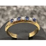 Ladies 9ct gold sapphire and diamond band. Set with 4 blue sapphires and 3 round brilliant cut