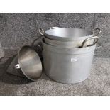 Set of three large graduated aluminium stock pans with stainless steel handles, and a sieve.