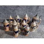 10 German steins with pewter lids, of various sizes.