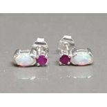 A pair of silver stud earrings set with ruby and opal 2.03g gross