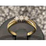 Ladies 9ct gold 3 stone diamond ring. Set with 3 round brilliant cut diamonds and 3 diamonds on each