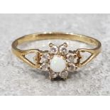 Ladies 9ct yellow gold cluster ring set with opal in the centre surrounded by eight cubic zirconias,