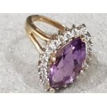 Ladies 9ct yellow gold amethyst + diamond cluste ring , featuring a marque cut amethyst In the