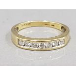 Ladies 18ct yellow gold diamond band, comprising of seven round brilliant cut diamonds, chanel set