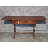 A reproduction mahogany sofa table by J Sydney Smith, raised on brass castors 149.5cm fully