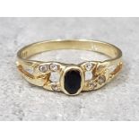 14ct yellow gold sapphire and white stone ring, comprising of a oval sapphire set in the centre with