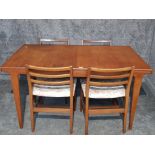 A teak extending dining table with one spare leaf 190cm fully extended 88cm wide, and four