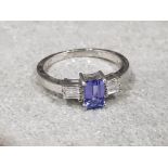 Ladies 9ct white gold tanzanite + diamond ring , featuring a emerald cut tanzanite set in the centre