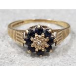 Ladies 9ct yellow gold sapphire & diamond cluster ring comprising of eight black sapphires with