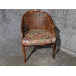 A 1930s style stained beech bergere armchair with lift out cusion.