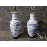 A pair of modern blue and white Chinese vases with dragon and cloud decoration 47cm high including