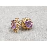 Ladies 9ct yellow gold amethyst studs , each stud set with a oval shaped amethyst in a fancy