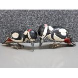 Two hand carved and painted wood antique confidence decoys in the form of spotted woodpeckers with