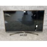 A 43" LG flatscreen TV and remote.