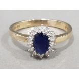 Ladies 9ct yellow gold sapphire & diamond cluster ring, featuring a oval blue sapphire in the centre