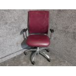 A burgandy leatherette and mesh swivel office chair by Verco.