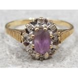 Ladies 9ct yellow gold purple stone & diamond cluster ring, featuring a oval purple stone in the