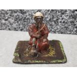 A cold painted bronze figure of an arab smoking a hookah pipe