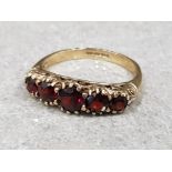 Ladies 9ct yellow gold five stone garnet ring, featuring five round garnet stones claw set across