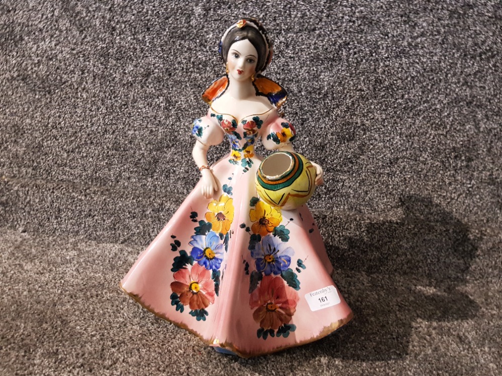 An Italian pottery figure of a lady holding a vase 39cm high.