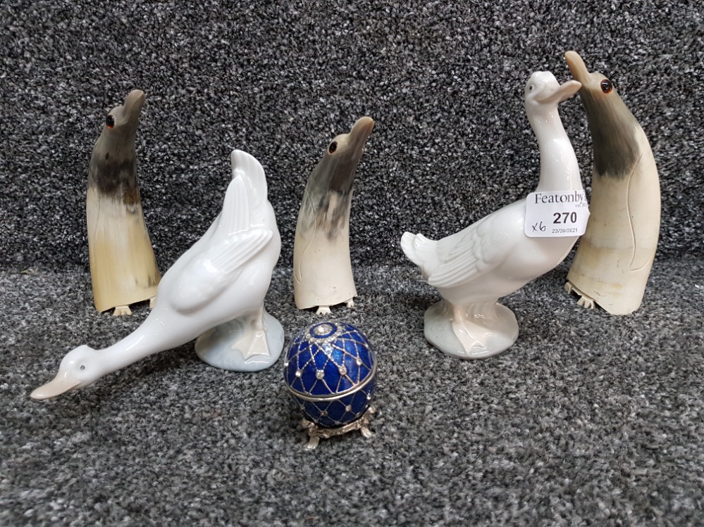 Three carved horn sculptures of penguins, two Nao Geese and a table clock in egg case.