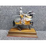 Vintage armored knight figure with jousting lance on horse, with wooden base, height 13"