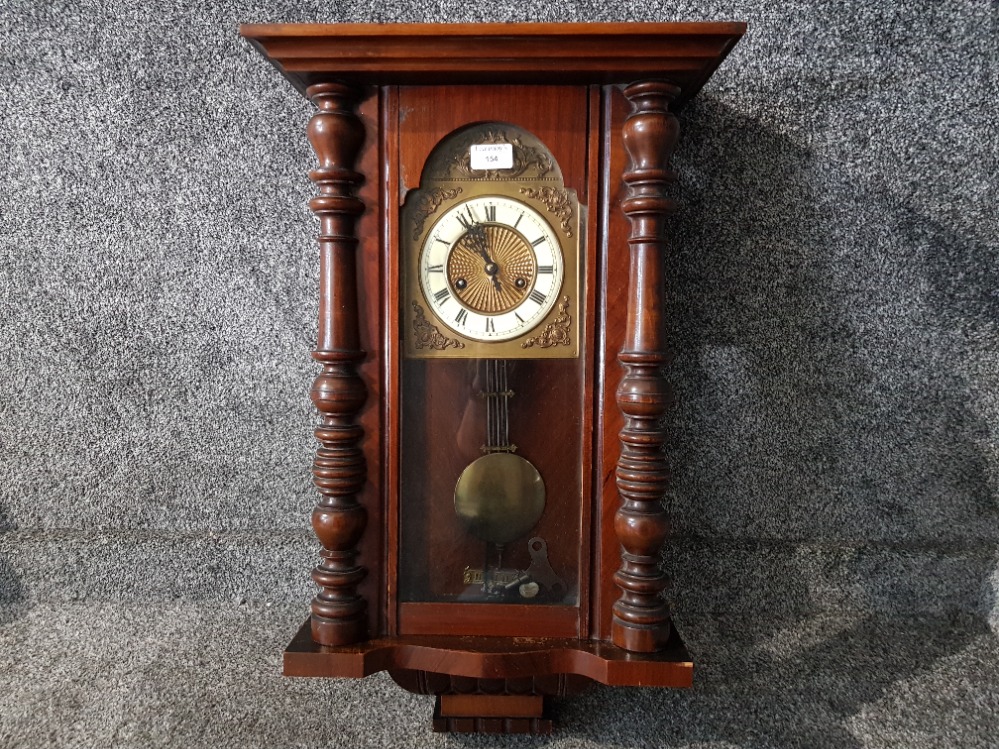 A reproduction mahogany Vienna style wall clock.
