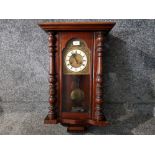 A reproduction mahogany Vienna style wall clock.