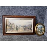 An oval oil painting of a Parisian street scene together with a colour print of a seaside town scene