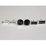 Three pairs of cufflinks In the Style of Hugo Boss, Ray-Ban and Gucci.