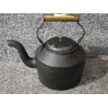 A cast metal and brass handled stove teapot.