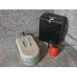 A metal storage box containing shoe cleaning items, a Jerry can and an oil can.