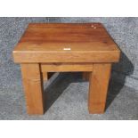 A heavy wooden square shaped occasional table 60 x 60cm.