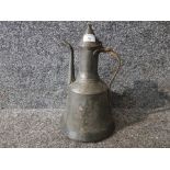 A Persian tin coffee pot with brass handle 37cm high.