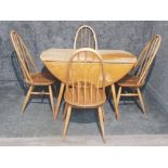 An ercol dining table and matching spindle back chairs.