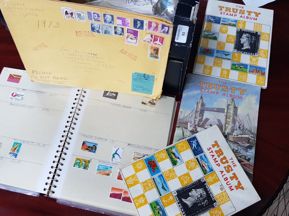 Box of mixed postage stamps from around the world, includes several albums
