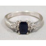 Ladies 9ct white gold sapphire & diamond ring, comprising of a blue emerald cut sapphire set with