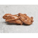 A finely carved Chinese hardwood netsuke depicting a rat towing a turtle.