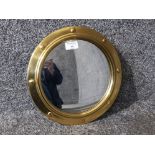A porthole style brass framed mirror by Peerage, 30cm diameter.