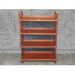 A stained wood four tier display unit 72 x 103 x 33cm.