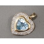 Ladies 9ct yellow gold stone set heart pendant comprising of a light blue heart in the centre