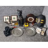 A wooden ornament of an Egyptian cat, two pewter chargers, an oak mantle clock by Andrew, zippo