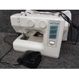 Vintage Janome new home sewing machine with protective cover