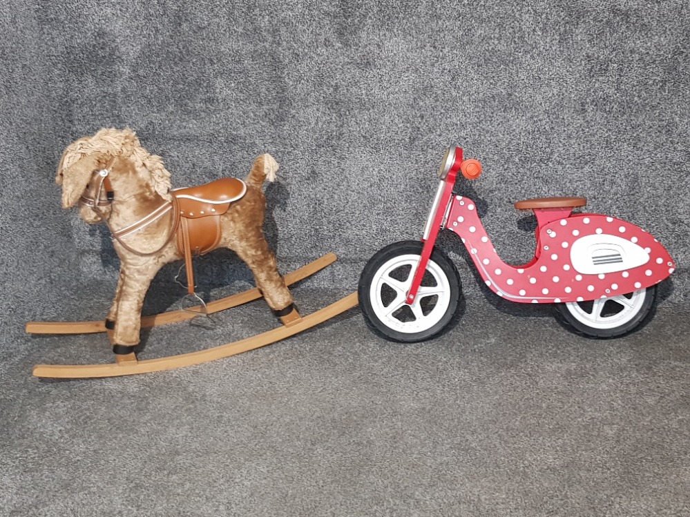 A rocking horse and a child's push along bike.