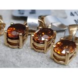 4 stamped 10k gold pendants with amber coloured stones, 3.4g gross