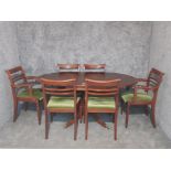 A Regency style mahogany drop leaf pedestal dinning table 157cm long, and a set of 4 + 2 dinning