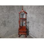 A reproduction mahogany valet stand, carved decoration and single drawer to base 142cm high.