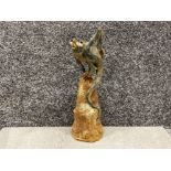 Grotesque figure on a Sulphur like Pinnacle by Toby King Blue moon Pottery. Signed to the inside