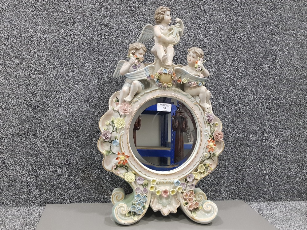 A late 19th century Sitzendorf porcelain toilet mirror decorated with cherubs and flowers 59 x