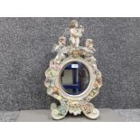 A late 19th century Sitzendorf porcelain toilet mirror decorated with cherubs and flowers 59 x